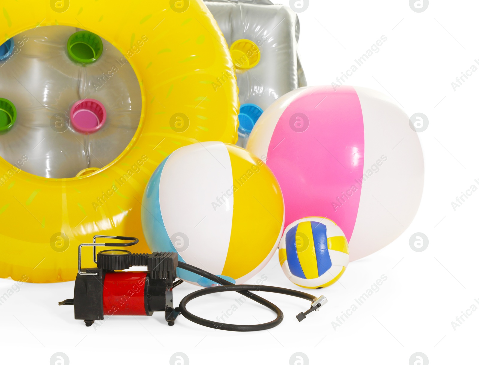 Inflatable ring, mattress, balls and air compressor isolated on white Photo of Inflatable ring, mattress, balls and air compressor isolated on white