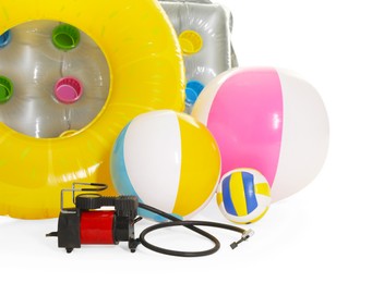 Photo of Inflatable ring, mattress, balls and air compressor isolated on white