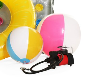 Photo of Inflatable ring, mattress, balls and air compressor isolated on white