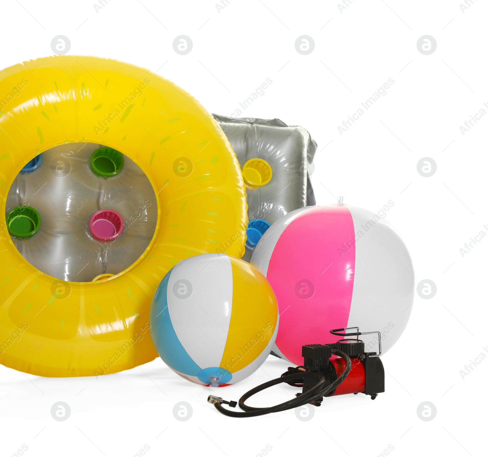 Inflatable ring, mattress, balls and air compressor isolated on white Photo of Inflatable ring, mattress, balls and air compressor isolated on white