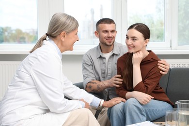 Photo of In vitro fertilization (IVF). Doctor encouraging young couple in reproductive clinic