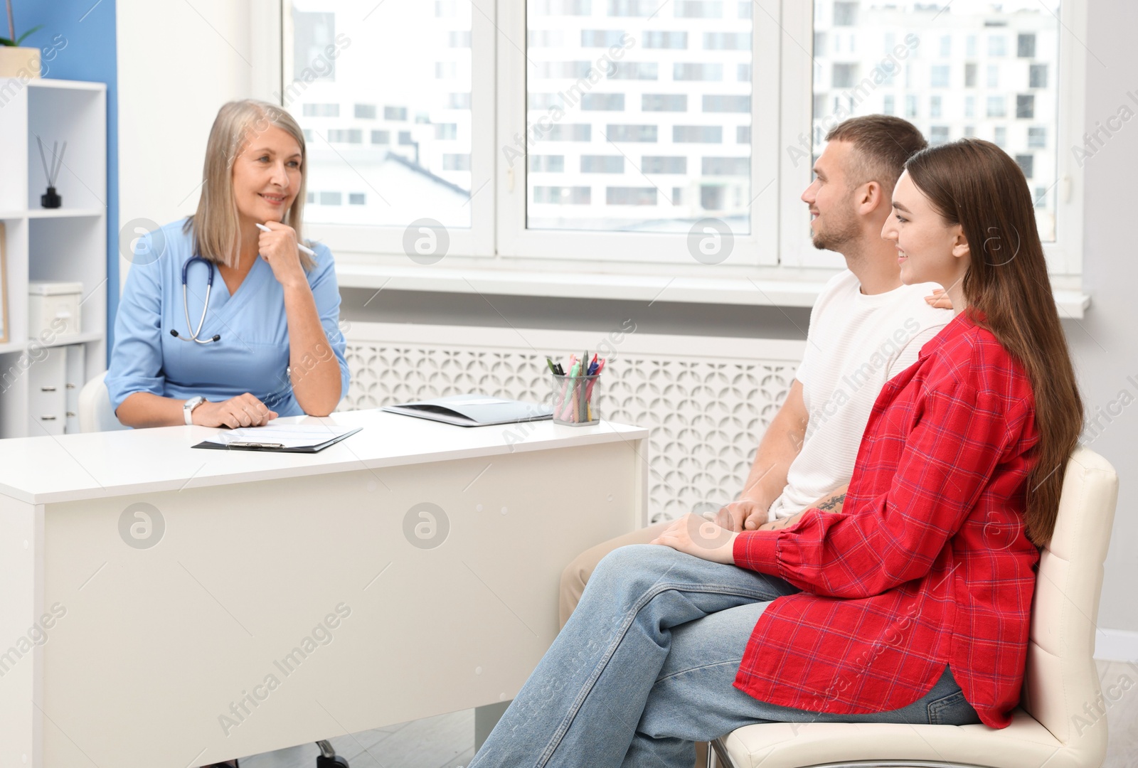 Photo of In vitro fertilization (IVF). Couple having consultation with doctor in reproductive clinic