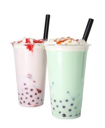 Photo of Tasty milk bubble tea in plastic cups isolated on white