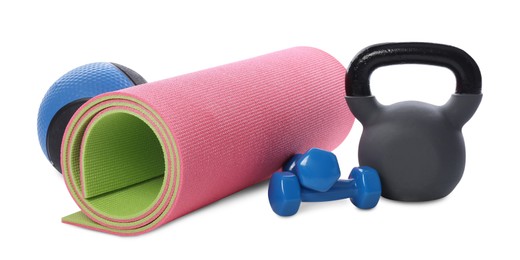 Photo of Medicine ball, dumbbells, kettlebell and fitness mat isolated on white