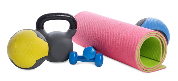 Photo of Medicine balls, dumbbells, kettlebell and fitness mat isolated on white