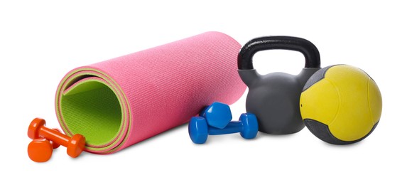 Photo of Medicine ball, dumbbells, kettlebell and fitness mat isolated on white