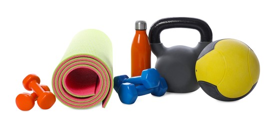 Photo of Medicine ball, dumbbells, kettlebell, water bottle and fitness mat isolated on white