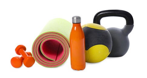 Photo of Medicine ball, dumbbells, kettlebell, water bottle and fitness mat isolated on white