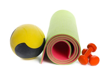Photo of Medicine ball, dumbbells and fitness mat isolated on white