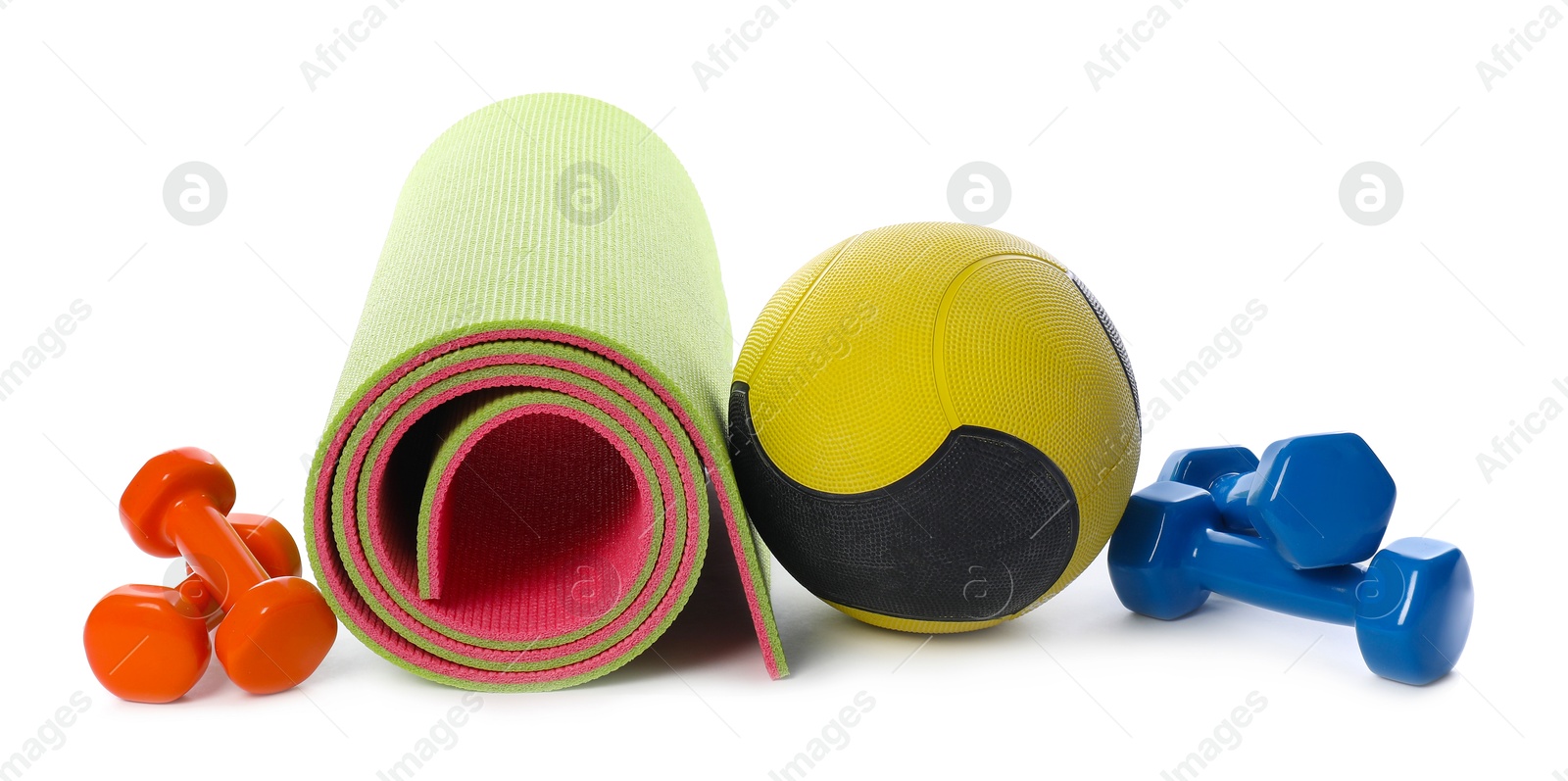 Medicine ball, dumbbells and fitness mat isolated on white Photo of Medicine ball, dumbbells and fitness mat isolated on white
