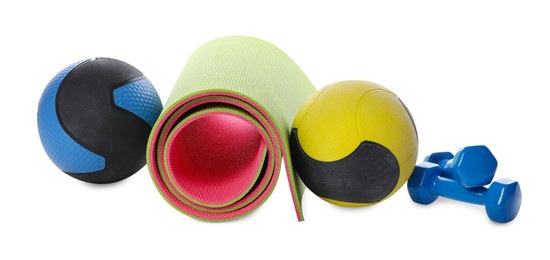 Photo of Medicine balls, dumbbells and fitness mat isolated on white