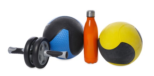 Photo of Medicine ball, dumbbells, ab wheel and water bottle isolated on white
