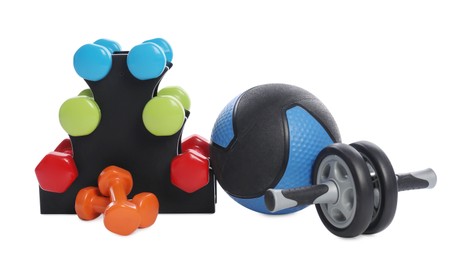 Photo of Medicine ball, dumbbells and ab wheel isolated on white