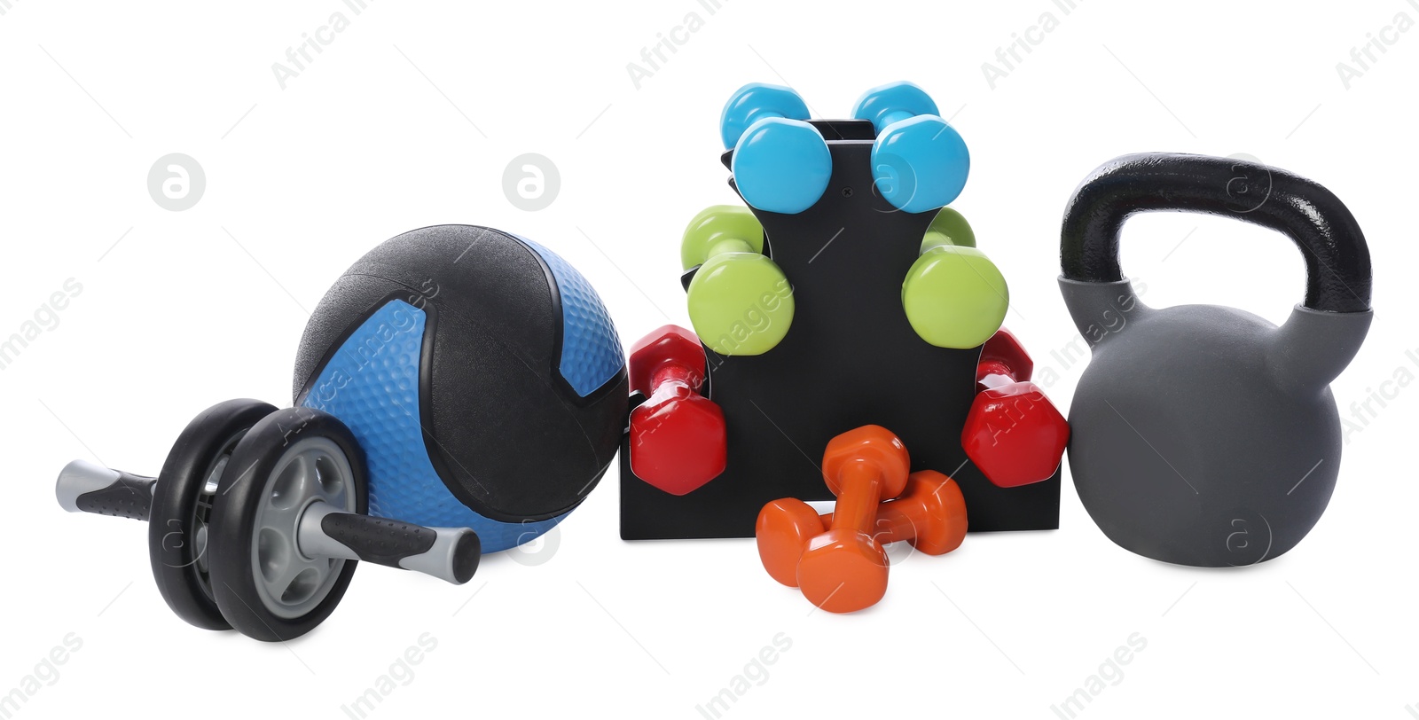 Medicine ball, dumbbells, kettlebell and ab wheel isolated on white Photo of Medicine ball, dumbbells, kettlebell and ab wheel isolated on white
