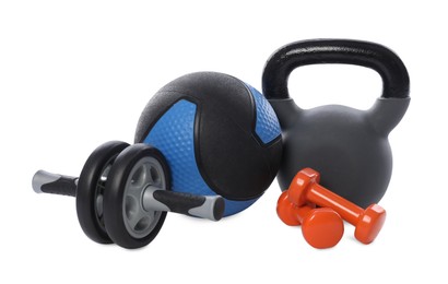 Photo of Medicine ball, dumbbells, kettlebell and ab wheel isolated on white