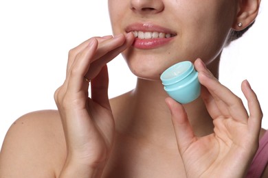 Photo of Young woman with lip balm on white background, closeup