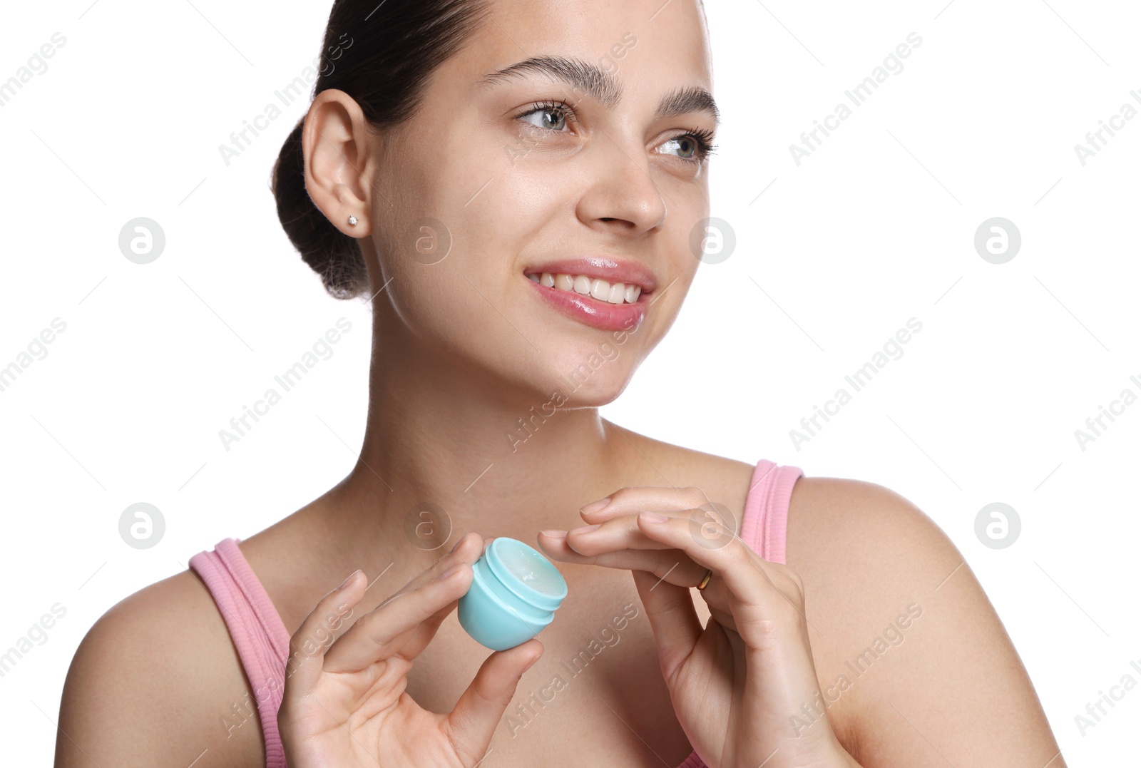 Young woman with lip balm on white background Photo of Young woman with lip balm on white background