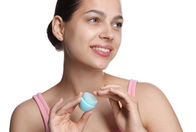 Photo of Young woman with lip balm on white background