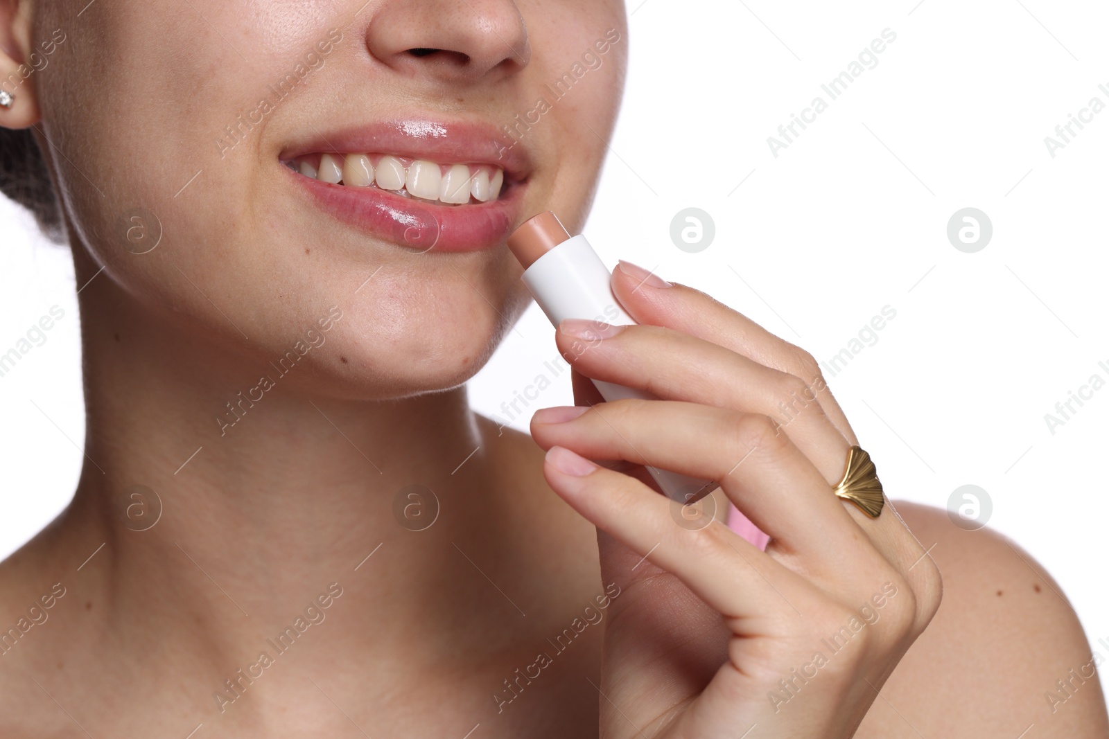 Young woman with lip balm on white background, closeup Photo of Young woman with lip balm on white background, closeup