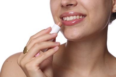 Photo of Young woman with lip balm on white background, closeup