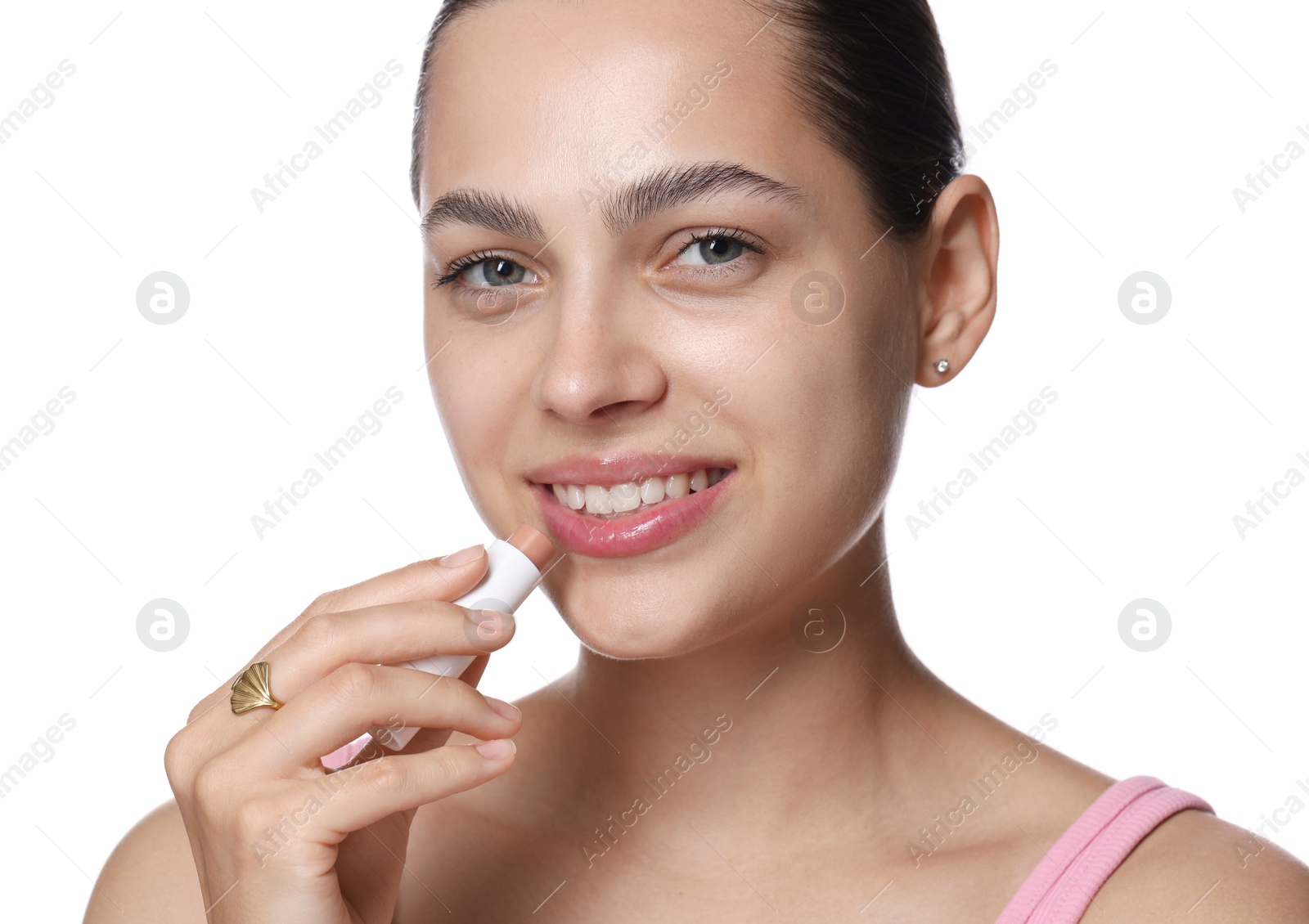 Young woman with lip balm on white background Photo of Young woman with lip balm on white background