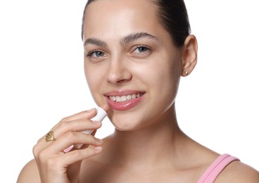 Photo of Young woman with lip balm on white background