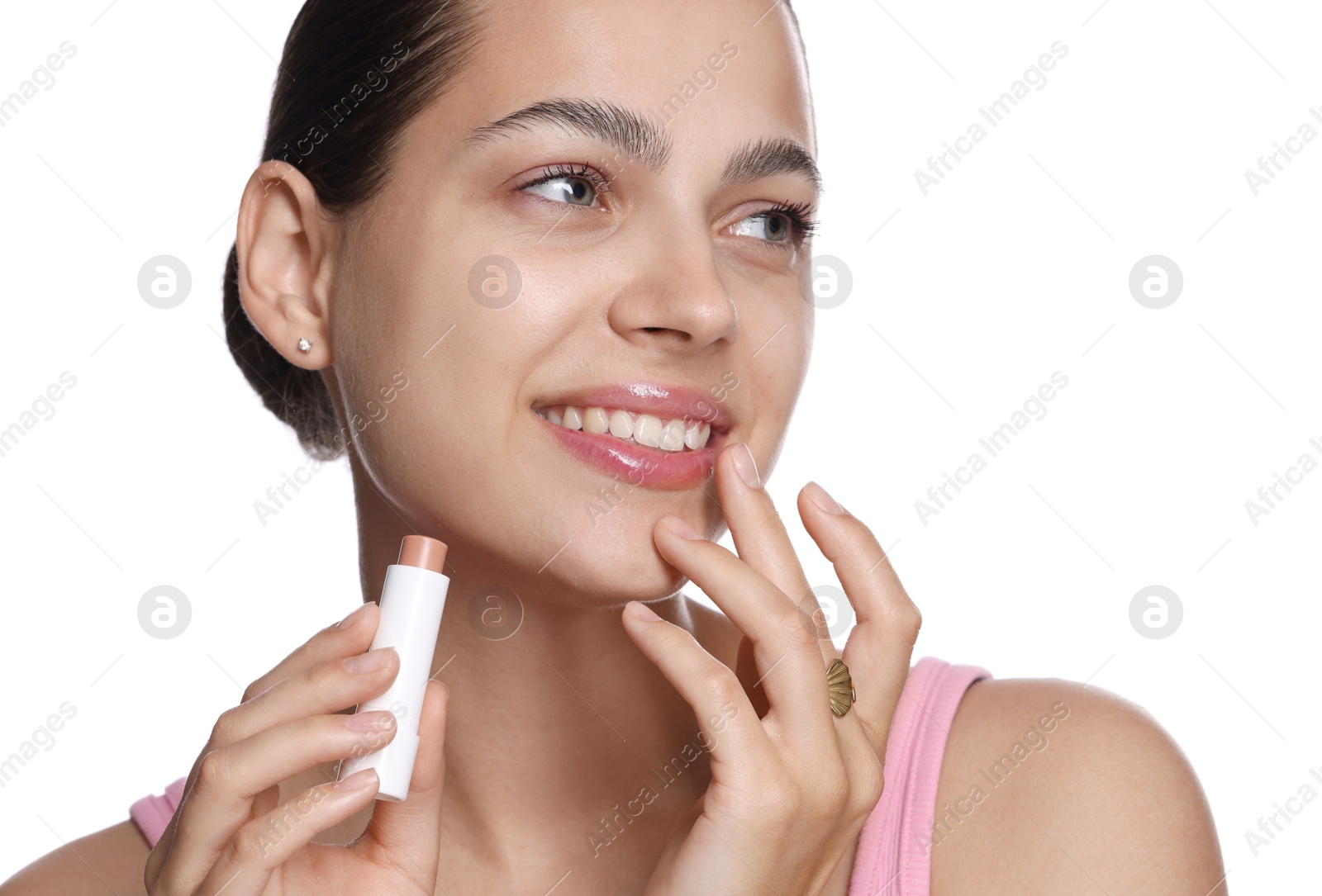 Young woman with lip balm on white background Photo of Young woman with lip balm on white background