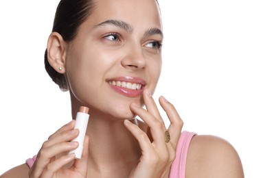 Photo of Young woman with lip balm on white background