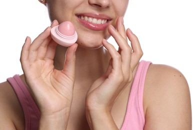 Photo of Young woman with lip balm on white background, closeup