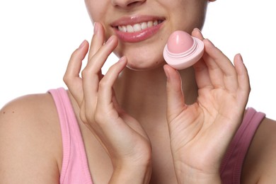 Photo of Young woman with lip balm on white background, closeup