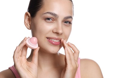 Photo of Young woman with lip balm on white background