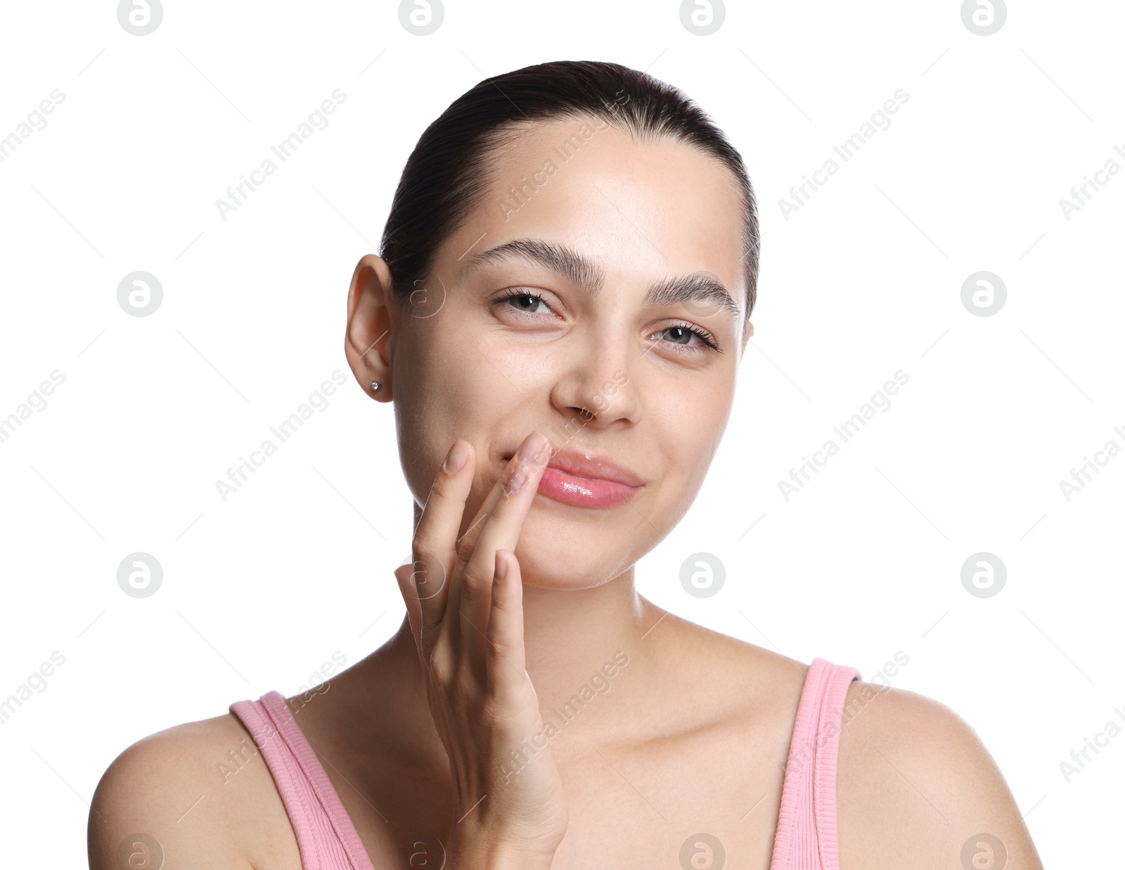 Young woman with lip balm on white background Photo of Young woman with lip balm on white background