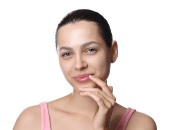 Photo of Young woman with lip balm on white background