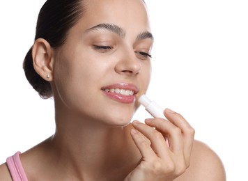 Photo of Young woman with lip balm on white background