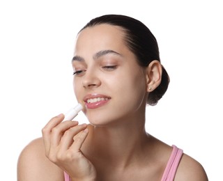 Photo of Young woman with lip balm on white background