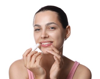 Photo of Young woman with lip balm on white background