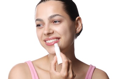 Photo of Young woman with lip balm on white background