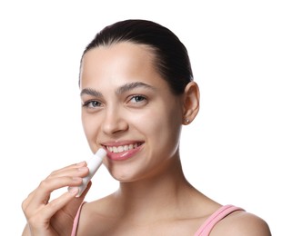 Photo of Young woman with lip balm on white background