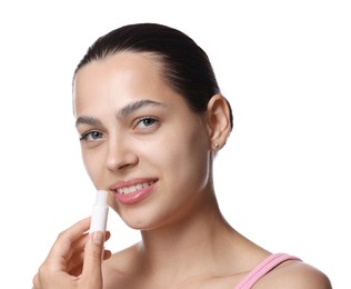 Photo of Young woman with lip balm on white background