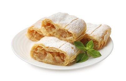 Photo of Pieces of tasty apple strudel with powdered sugar and mint isolated on white