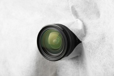 Photo of Hidden camera lens through torn hole in white fabric
