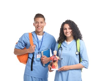 Photo of Medical students with human body model and book on white background