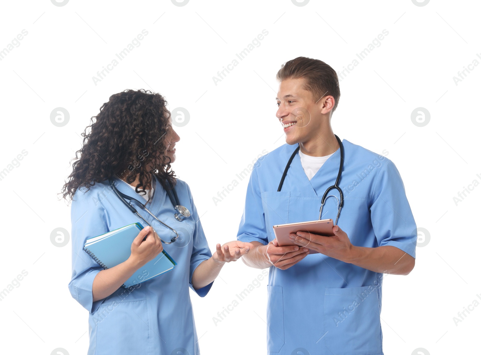 Medical students with tablet and books on white background Photo of Medical students with tablet and books on white background