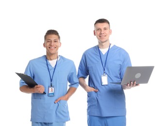 Photo of Medical students with clipboard and laptop on white background