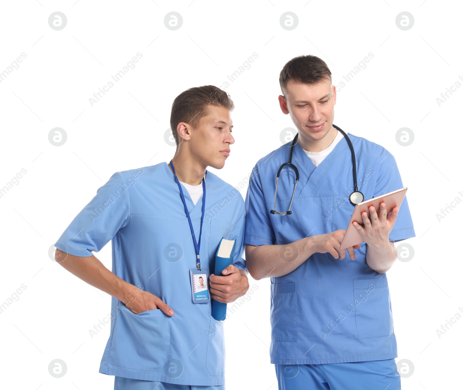 Medical students with tablet and book on white background Photo of Medical students with tablet and book on white background