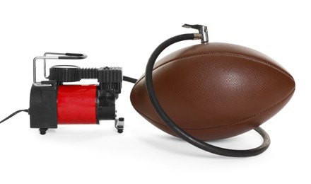 Photo of American football ball and air compressor isolated on white