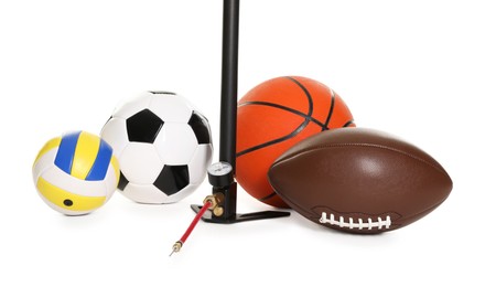 Photo of Different sport balls and manual air pump isolated on white