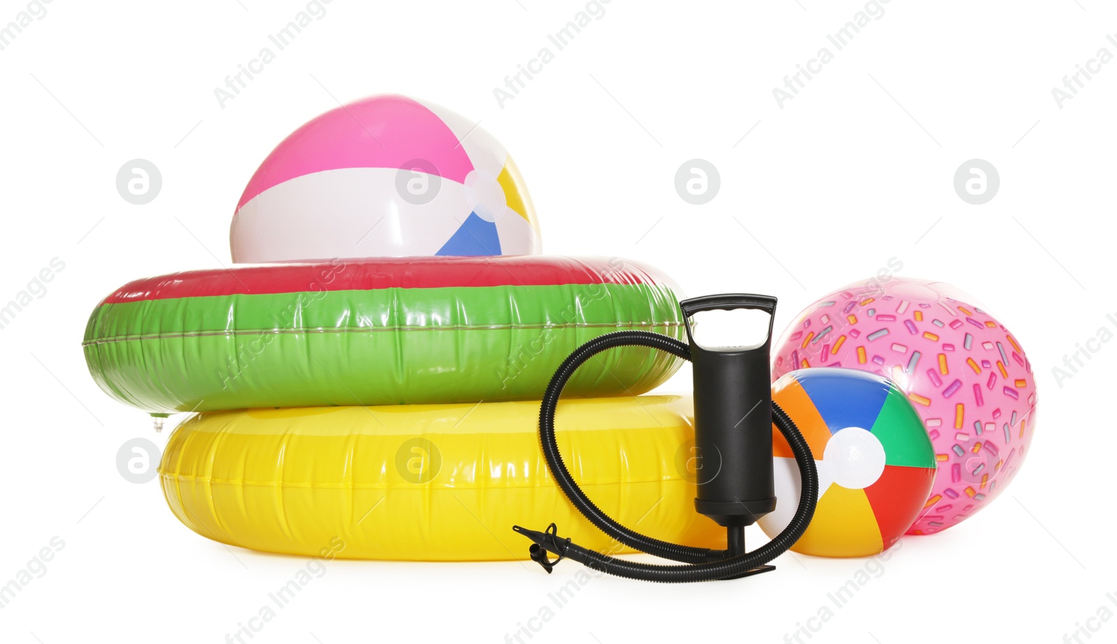 Inflatable rings, balls and manual air pump isolated on white Photo of Inflatable rings, balls and manual air pump isolated on white