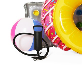 Photo of Inflatable rings, mattress, ball and manual air pump isolated on white