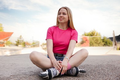 Photo of Happy woman with roller skates on street